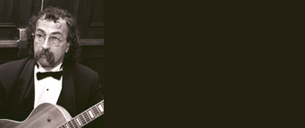 Rich Falco playing guitar in a tuxedo